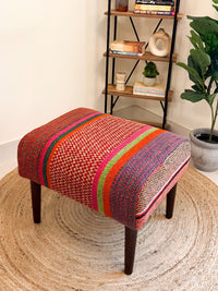 Upholstered bench featuring handwoven Andean frazada fabric with naturally dyed colors for modern home decor and interiors.