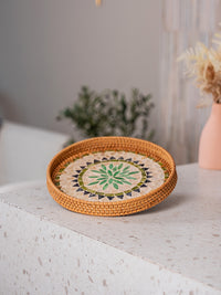 Handwoven round rattan serving tray with for home decor and serving purpose.