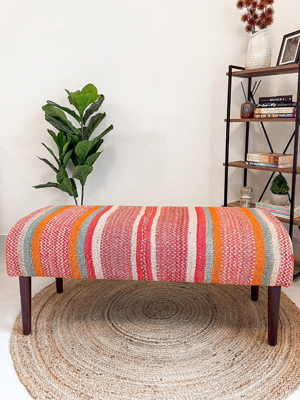 Frazada bench with striped patterns in pink and orange tones. Ideal for styling interiors and home decor purpose.