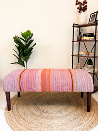 Frazada bench with striped patterns in pink and orange tones. Ideal for styling interiors and home decor purpose.