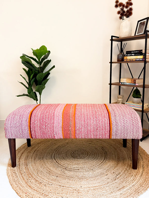 Frazada bench with striped patterns in pink and orange tones. Ideal for styling interiors and home decor purpose.