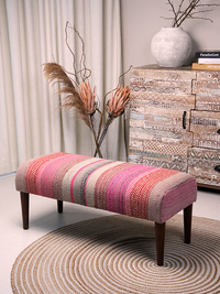Full view of Frazada bench with striped patterns in shades of pink. Ideal for styling interiors and home decor purpose.