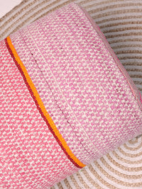 Close up shot of Frazada bench with striped patterns in pink and orange tones. Ideal for styling interiors and home decor purpose.