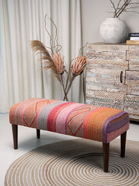 Full view of Frazada bench with striped patterns in pink and orange tones. Ideal for styling interiors and home decor purpose.