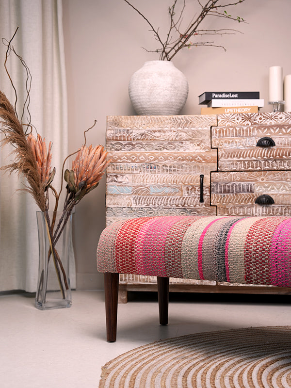 Frazada bench with striped patterns in pink and orange tones. Ideal for styling interiors and home decor purpose.