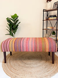 Frazada bench with striped patterns in pink and orange tones. Ideal for styling interiors and home decor purpose.