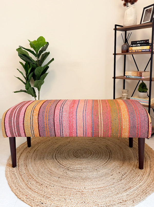 Frazada bench with striped patterns in pink and orange tones. Ideal for styling interiors and home decor purpose.