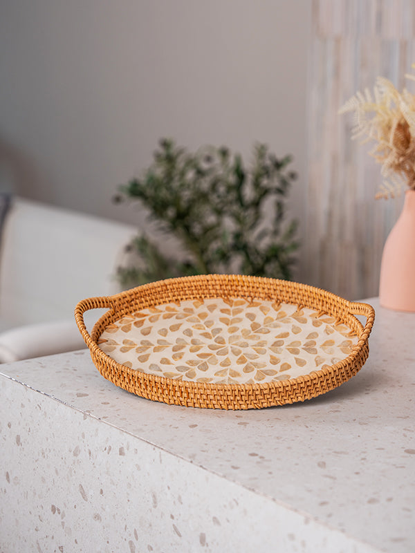 Handwoven rattan tray with handles for home decor and serving purpose.